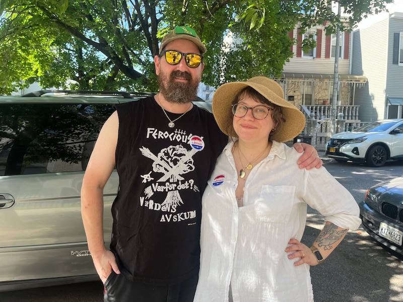 A couple stand outside a polling place.